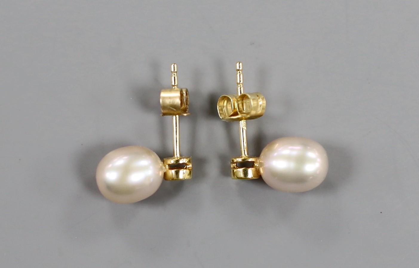 A modern pair of 18ct gold, cultured pearl and diamond set ear studs, 12mm, gross weight 2.3 grams.